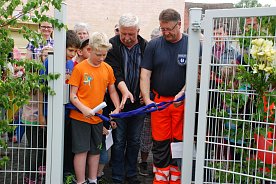 Bild: Ein historischer Augenblick: Der erste &ouml;ffentliche Spielplatz am Klosterplatz ist er&ouml;ffnet. Jamy Rudatz (10) aus der 3. Klasse der Schule am Schlo&szlig;platz und Roland Schmidt, Betriebsleiter des Eigenbetriebs Betriebshof (verantwortlich f&uuml;r die Spielplatzplanung) f&uuml;hrten die Scheren.