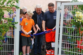Ein historischer Augenblick: Der erste &ouml;ffentliche Spielplatz am Klosterplatz ist er&ouml;ffnet. Jamy Rudatz (10) aus der 3. Klasse der Schule am Schlo&szlig;platz und Roland Schmidt, Betriebsleiter des Eigenbetriebs Betriebshof (verantwortlich f&uuml;r die Spielplatzplanung) f&uuml;hrten die Scheren. (Foto: Jochen Miche)