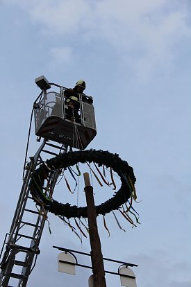 Bild: Um zu manchem H&ouml;hepunkt zu gelangen, braucht es auch mal die Helftaer Feuerwehrleiter - zum Beispiel um den Kranz des Maibaumes zu setzen.