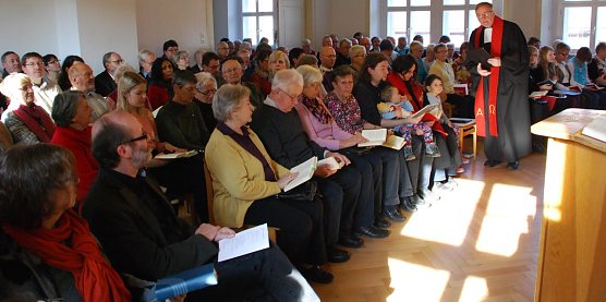 Selbst Sonne und Fenster spielten mit bei diesem Festgottesdienst im Sangerh&auml;user Gemeindehaus: Ein Kreuz zeigt sich auf dem Parkett. (Foto: Jochen Miche)
