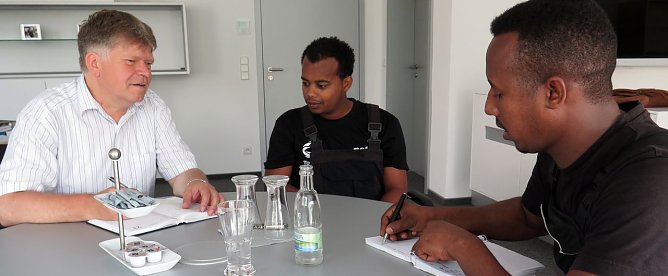Biniam Teklay (rechts) und Michael Teclom Aslamesh im Gespr&auml;ch mit dem Ausbildungsverantwortlichen Achit T&ouml;lle. (Foto: nnz)